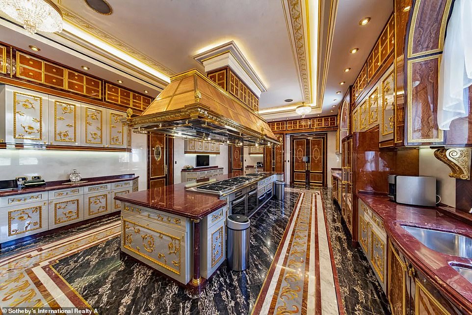 The huge home, which was inspired by Baroque and Rococo architecture and features marble flooring, has a huge interior space of 69,000sq ft. The kitchen is pictured above