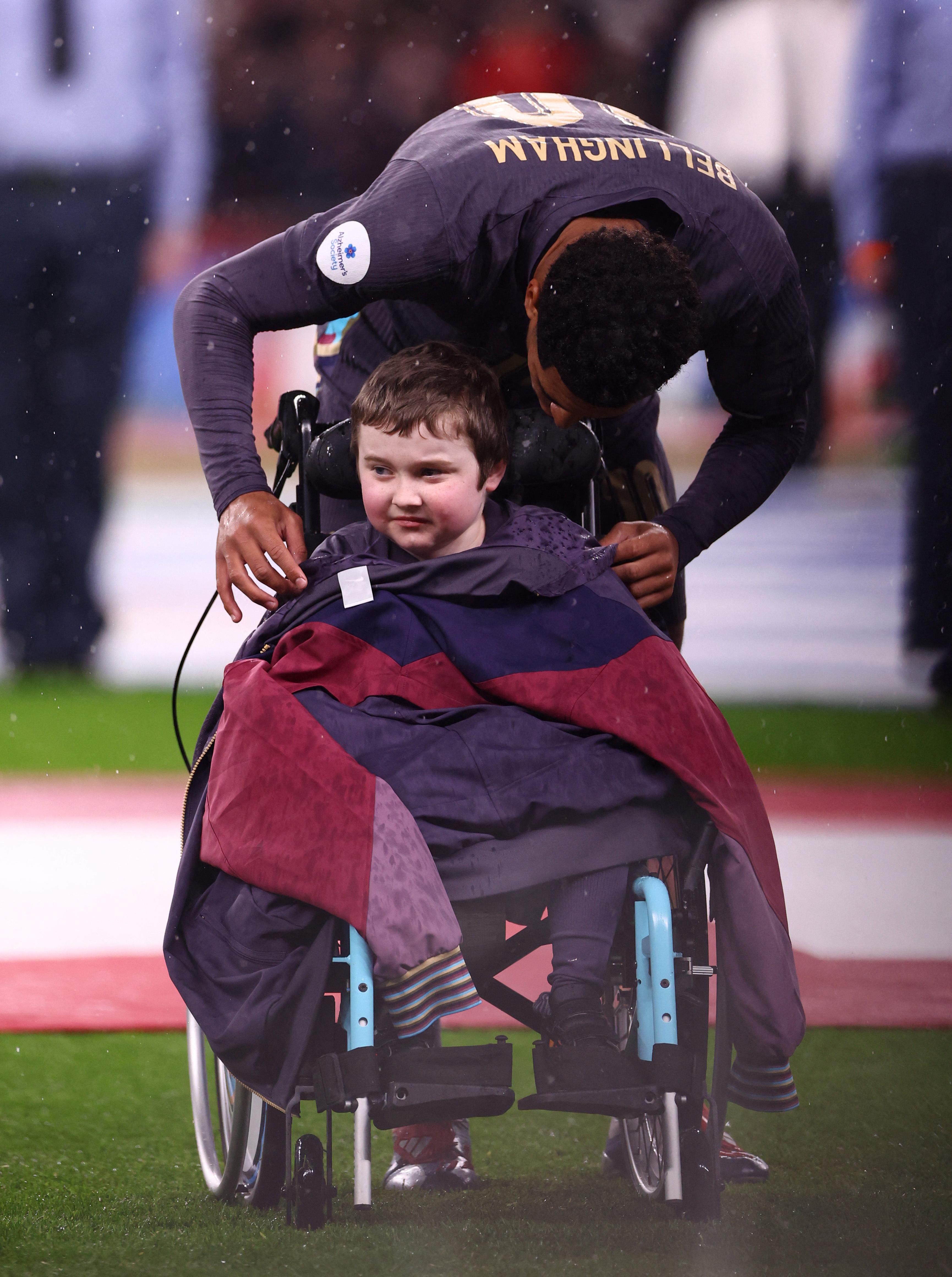 Touching moment as England star Bellingham gives his tracksuit top to  mascot in wheelchair as it rains at Wembley | The Sun