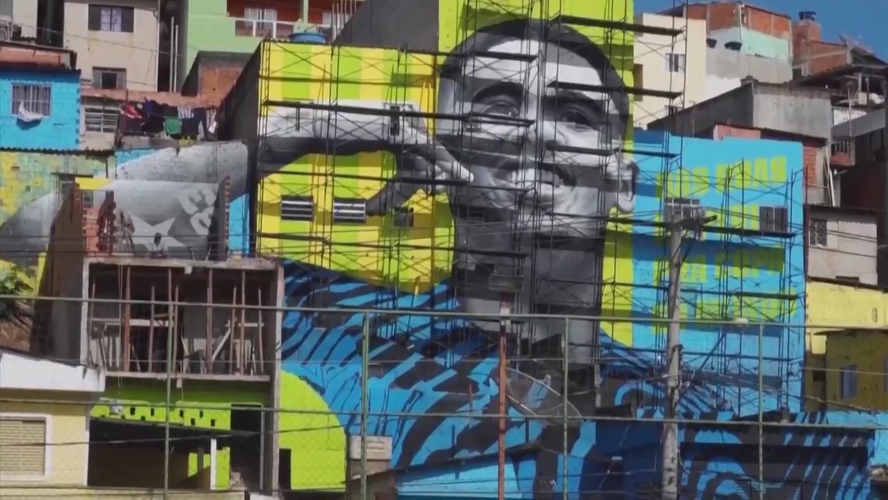 In his old neighbourhood, a mural of Jesus is painted on the wall