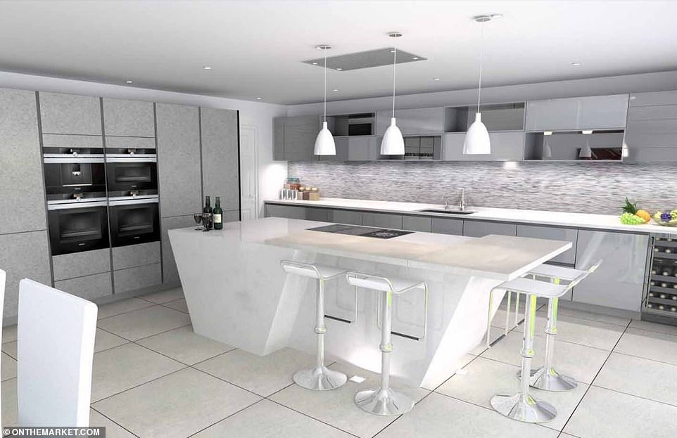 The stunning kitchen includes a breakfast bar and island hob, with separate ovens, hanging lights and and a seating area