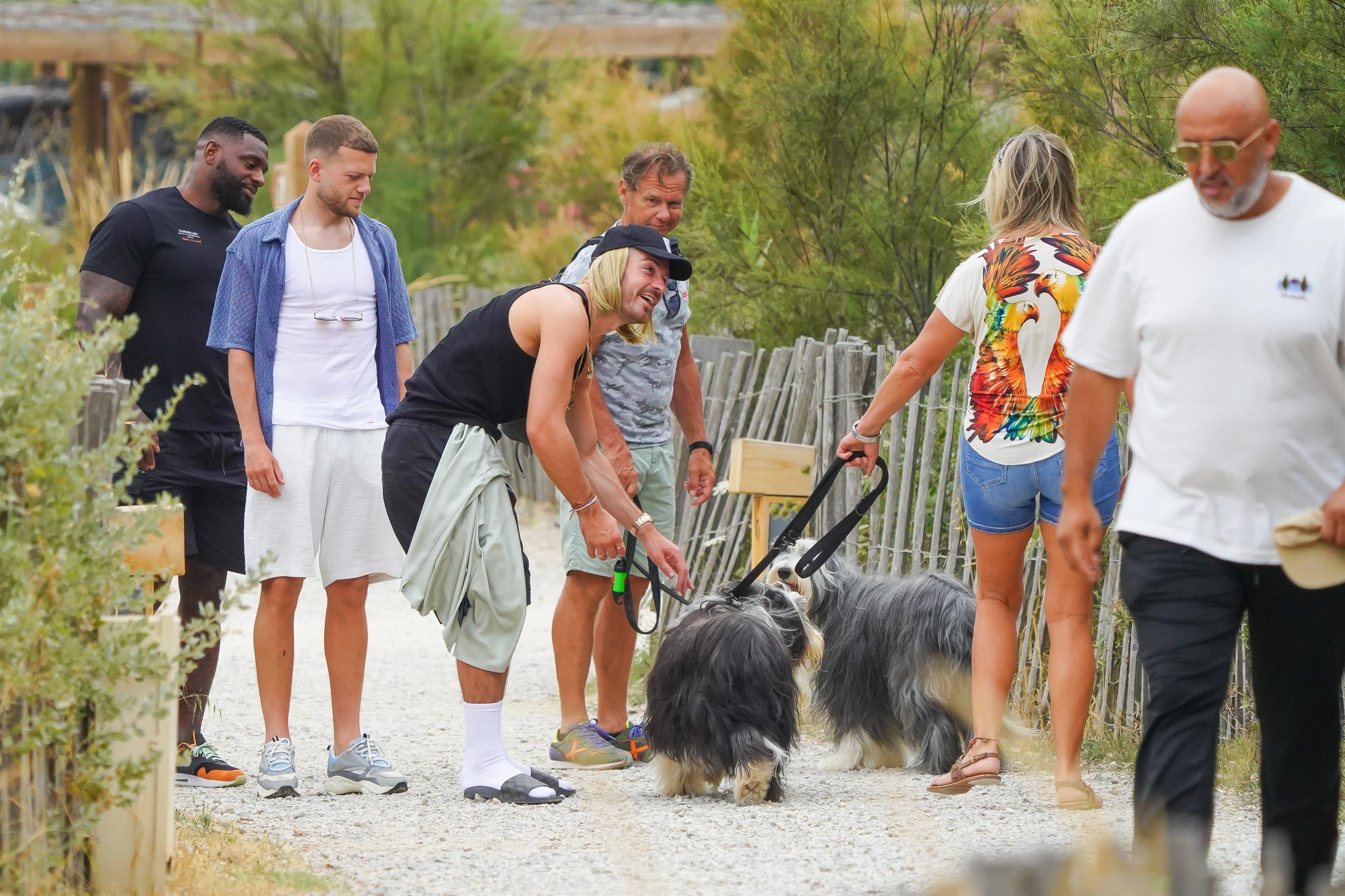 He was seen smiling as he petted two dogs on Saturday