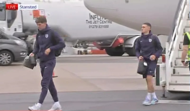 John Stones and Foden looked downtrodden as they made their way across the landing ground