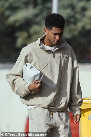 Jude Bellingham clutches a £1,500 Goyard washbag as he runs errands back in Madrid after pulling out of the England squad through injury | Daily Mail Online