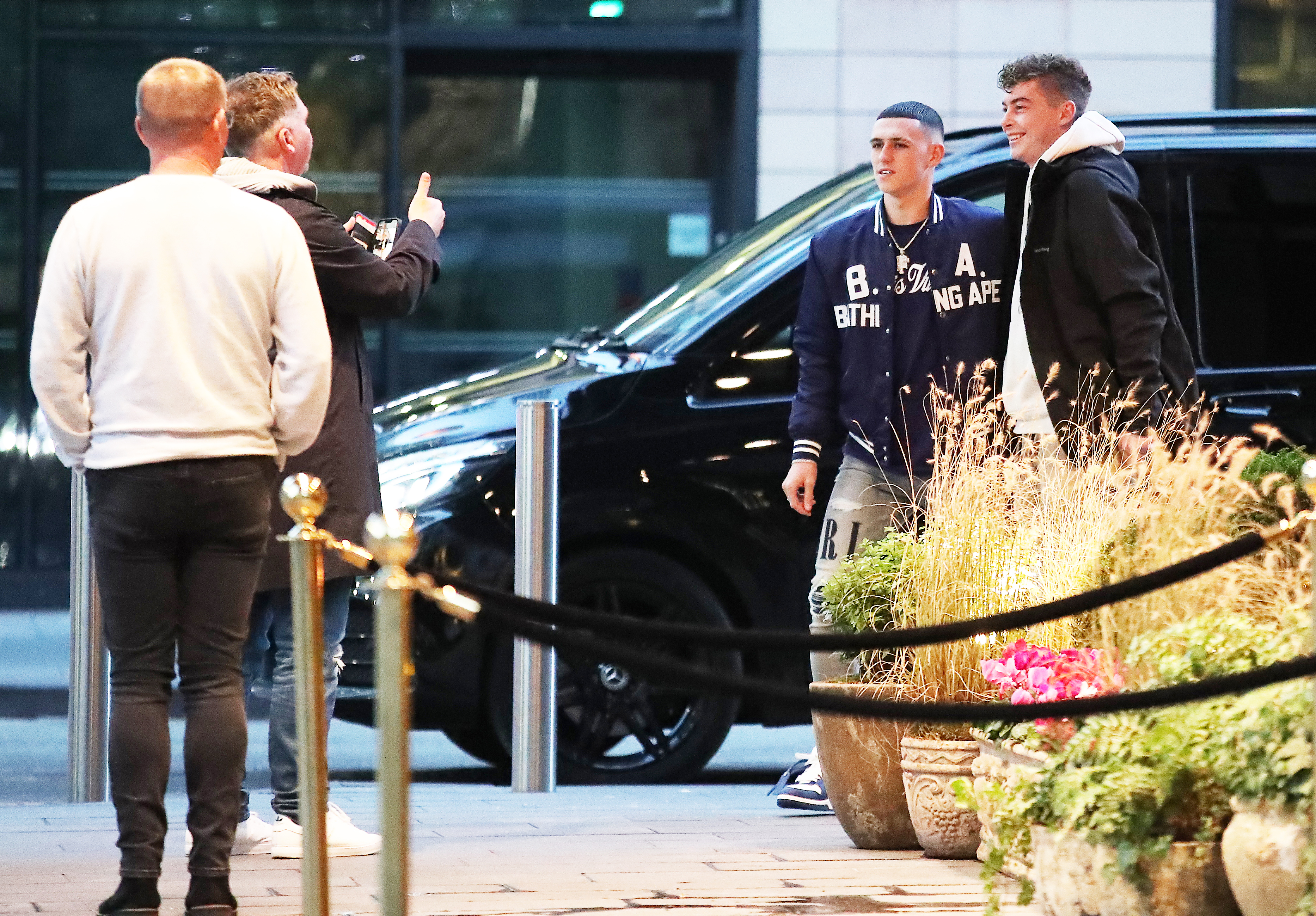 Foden took a picture with a fan as he arrived at The Ivy